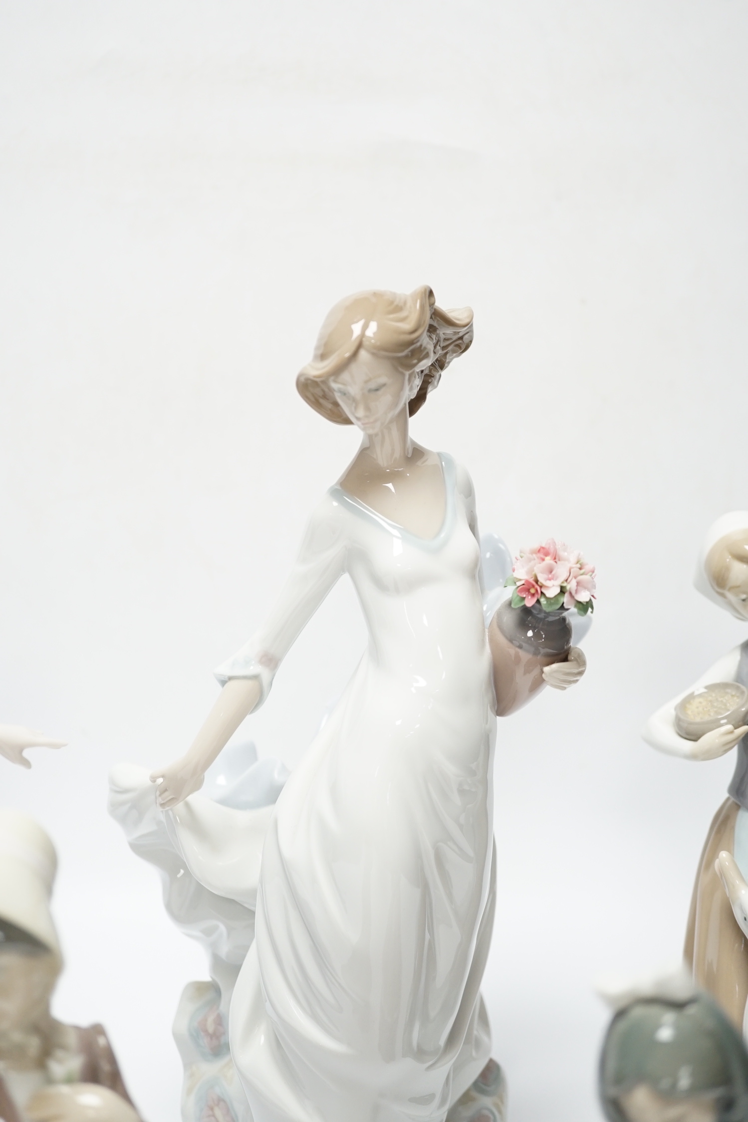 Four Lladro figurines; Reverie Moment, a model of a Ballet Dancer, and three other figurines (only two boxed)